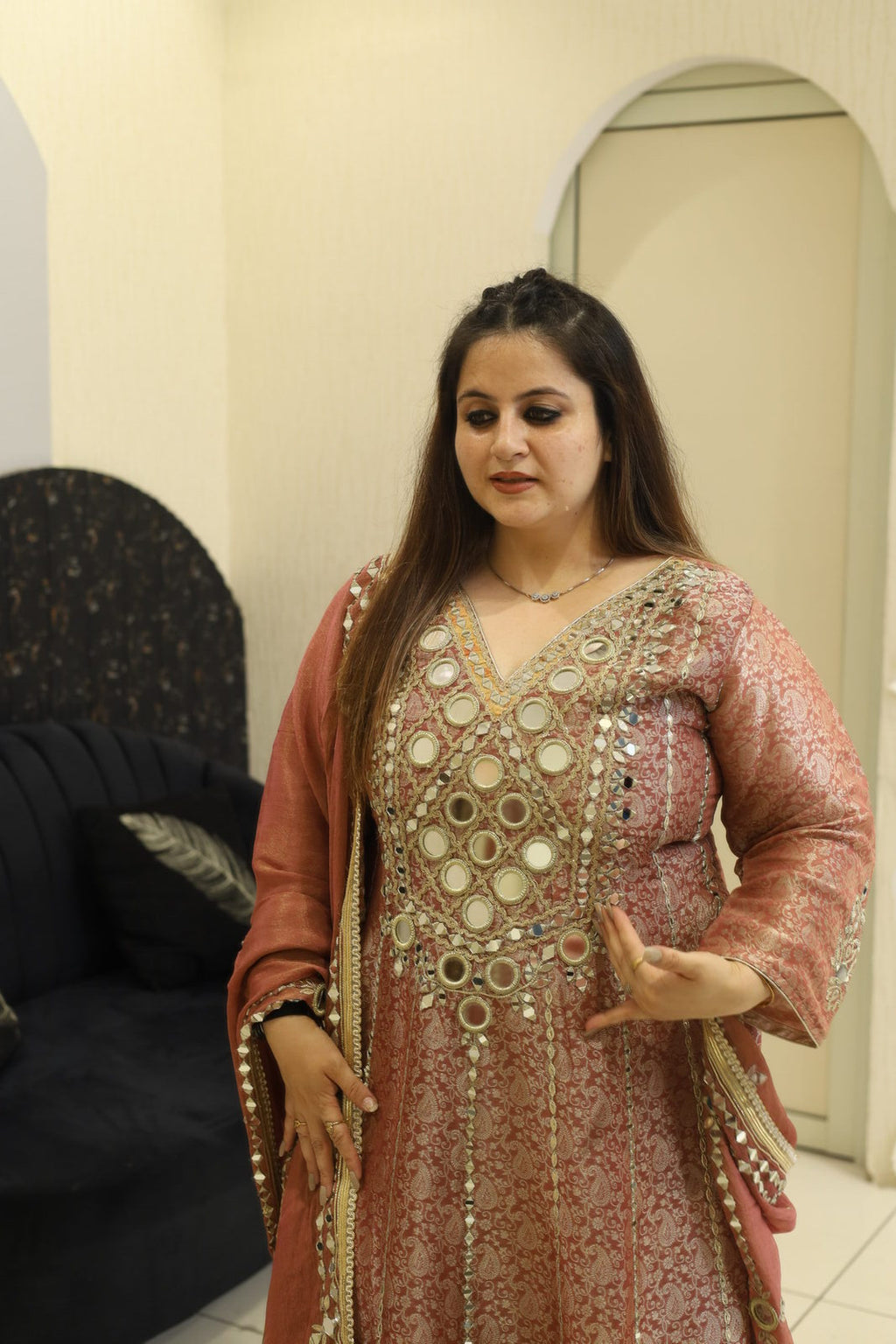 Woman wearing a pink floral embroidered button-down co-ord set with long sleeves