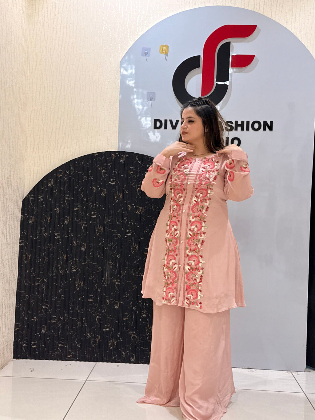 Woman in a pink floral embroidered co-ord set with palazzo pants
