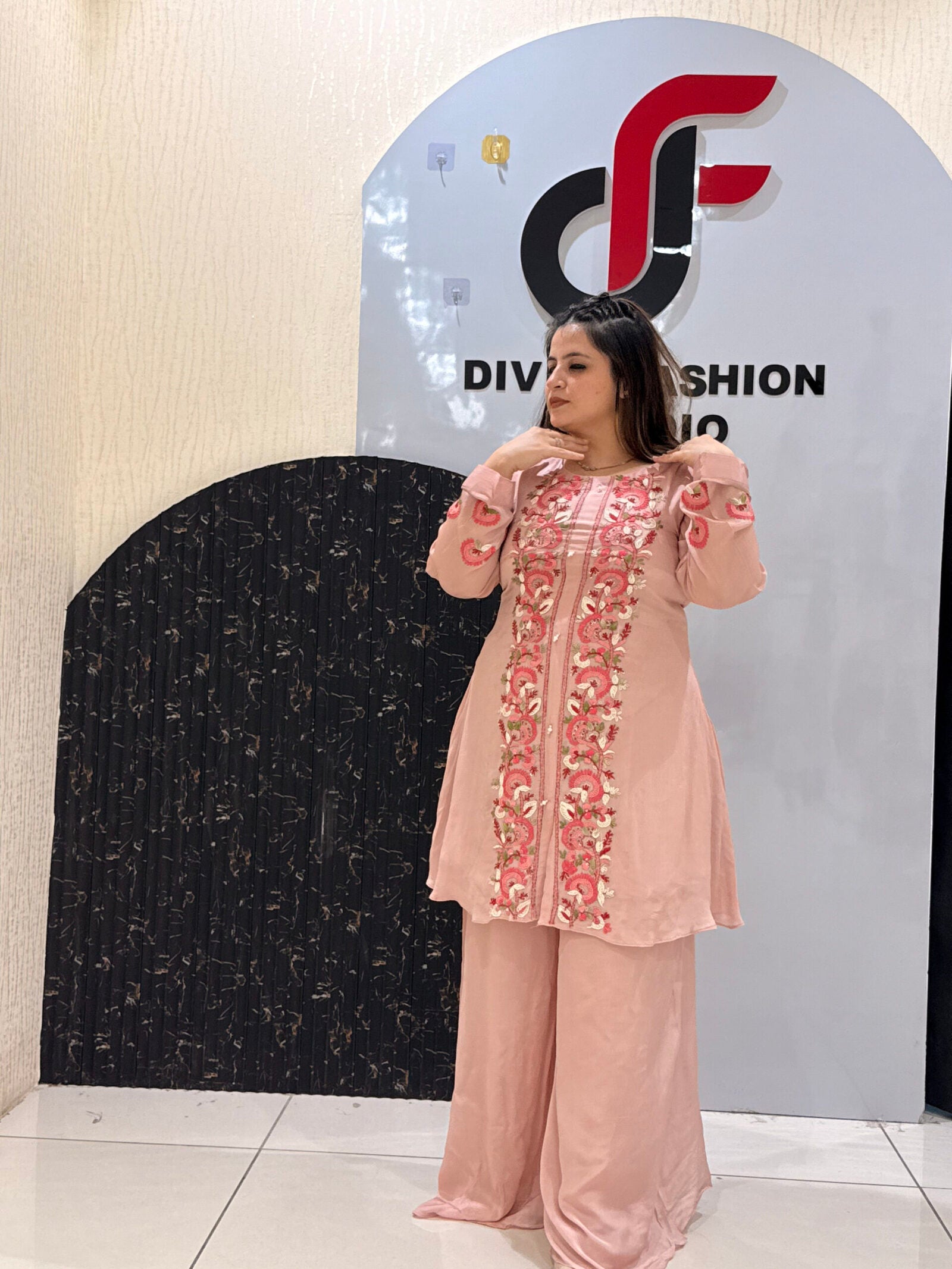 Woman in a pink floral embroidered co-ord set with palazzo pants