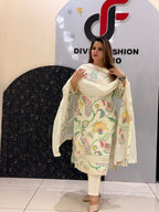 Woman in a cream floral embroidered button-down co-ord set with a matching dupatta.