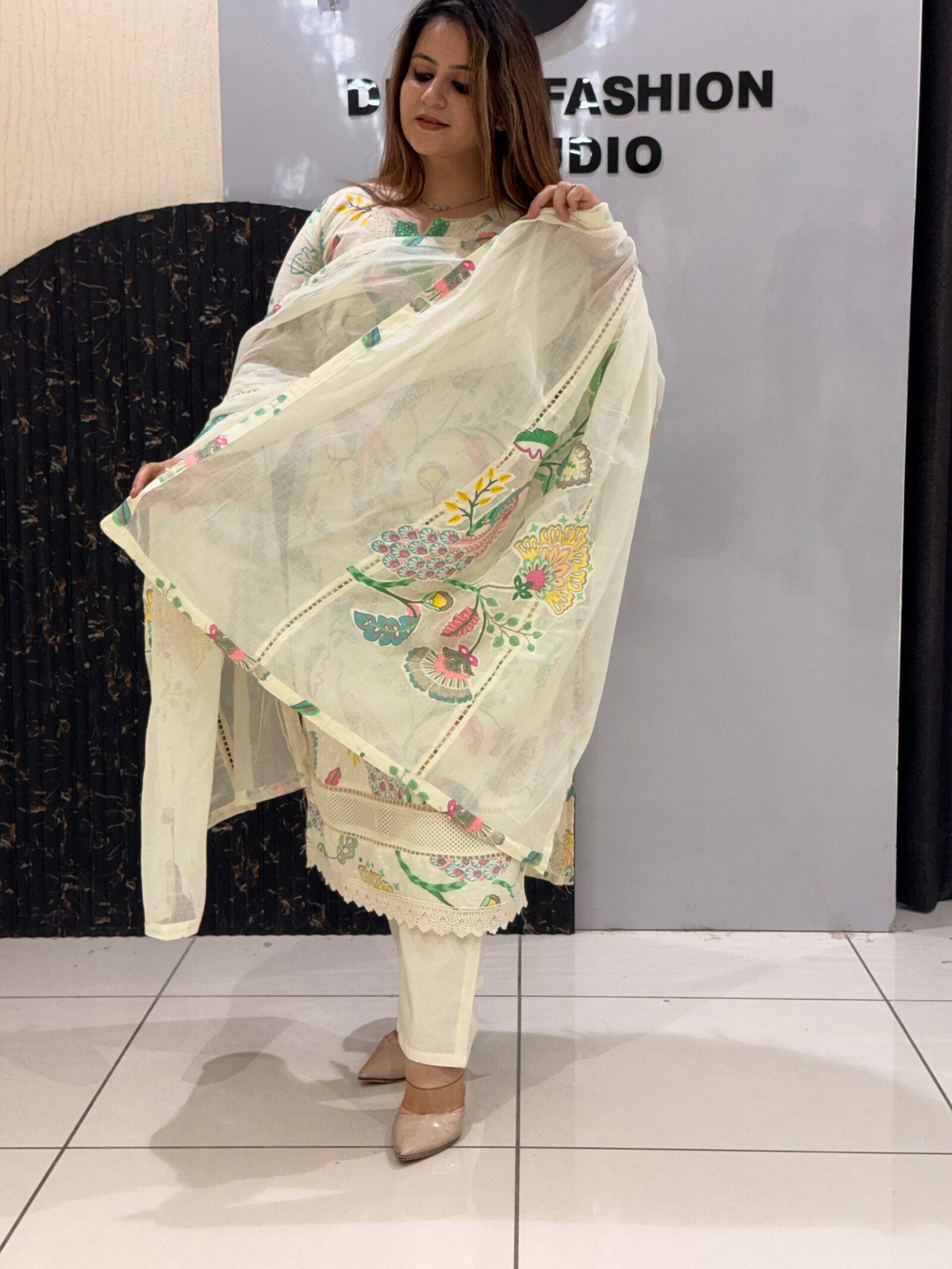 Woman in a cream floral embroidered button-down co-ord set with matching pants and dupatta.