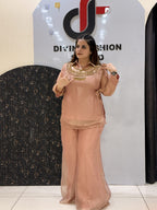 Woman in peach floral embroidered button-down co-ord set with wide-leg pants.