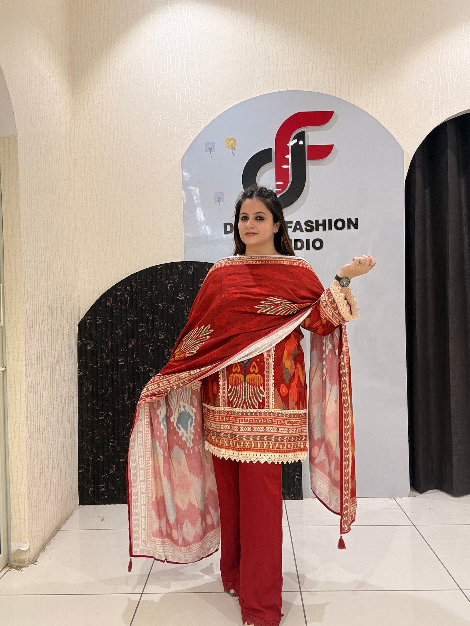 Elegant red cotton suit set featuring intricate multicolor embroidery and a matching printed dupatta.