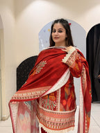 Elegant red cotton suit set featuring intricate multicolor embroidery and a matching printed dupatta.