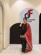 Elegant black pure cotton suit set featuring red and beige embroidery with a matching printed dupatta
