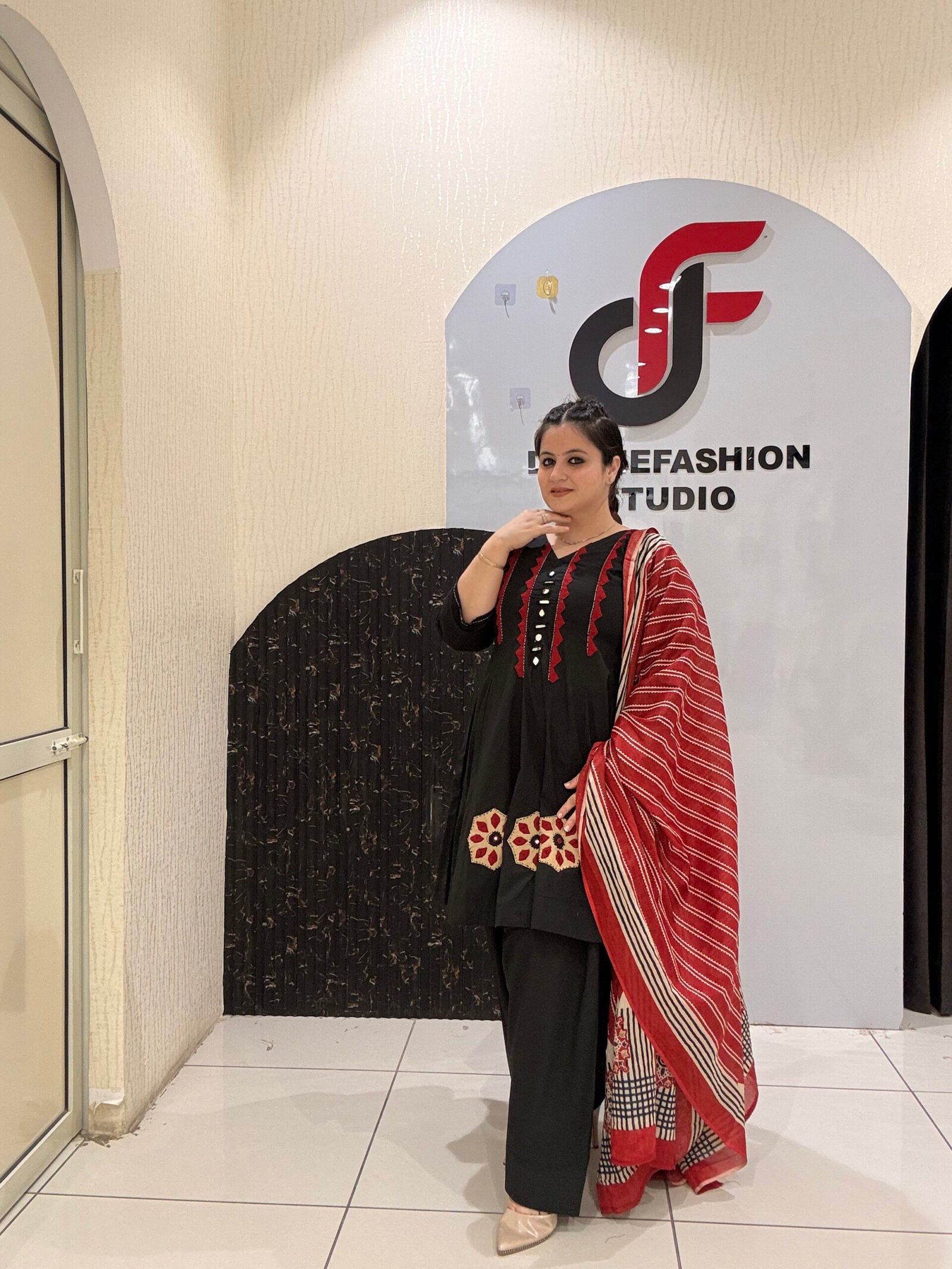 Elegant black pure cotton suit set featuring red and beige embroidery with a matching printed dupatta