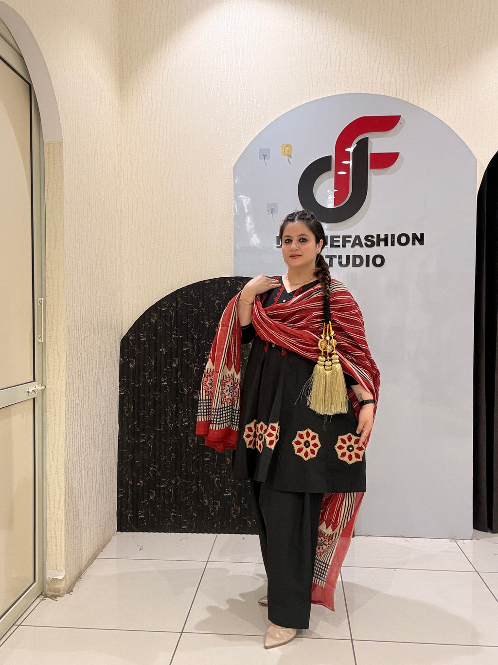Elegant black pure cotton suit set featuring red and beige embroidery with a matching printed dupatta