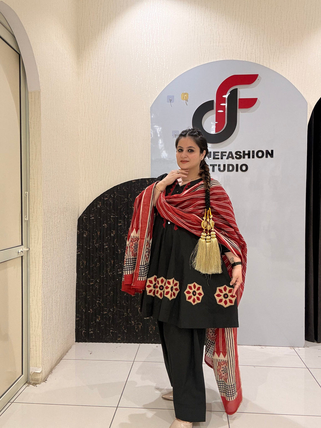 Elegant black pure cotton suit set featuring red and beige embroidery with a matching printed dupatta