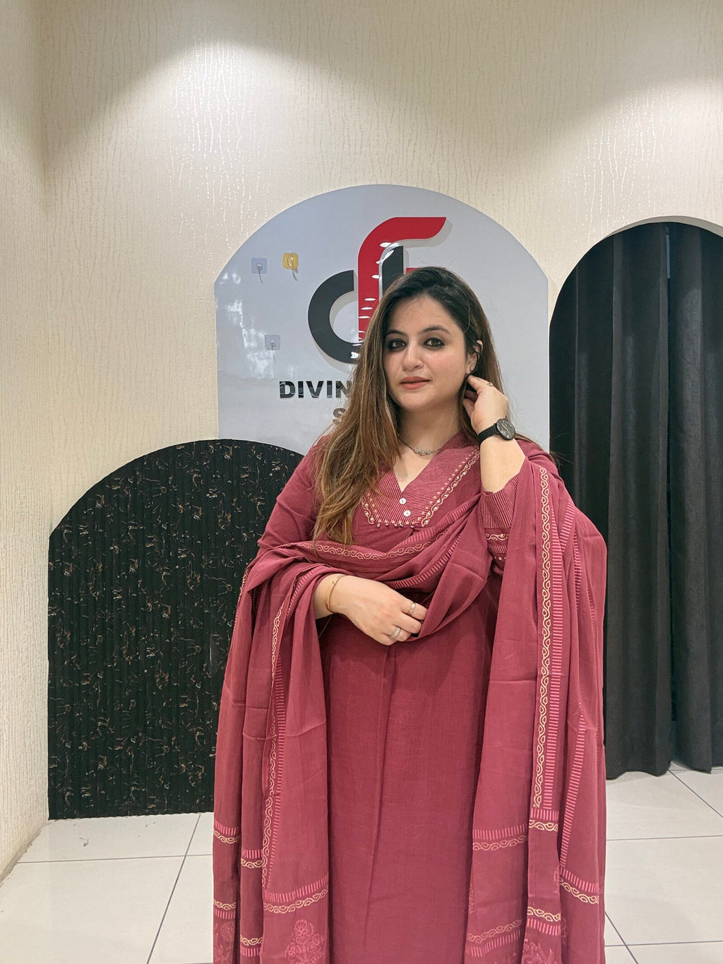 Graceful maroon pure cotton suit featuring delicate embroidery and a matching dupatta
