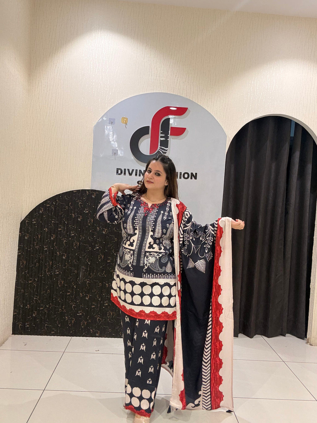 Elegant black Maslin suit featuring vibrant red and white prints with a matching dupatta
