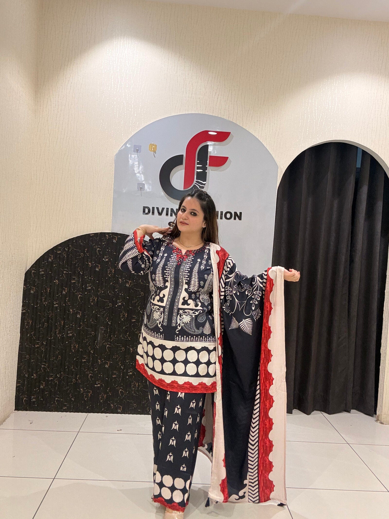 Elegant black Maslin suit featuring vibrant red and white prints with a matching dupatta