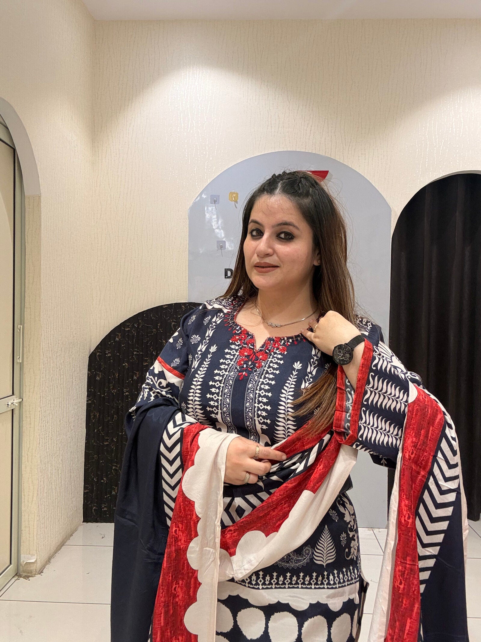 Elegant black Maslin suit featuring vibrant red and white prints with a matching dupatta