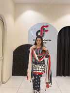 Elegant black Maslin suit featuring vibrant red and white prints with a matching dupatta