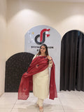 Elegant cream cotton suit featuring floral embroidery in red and blue tones, paired with a contrasting red dupatta.