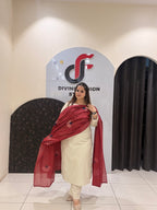 Elegant cream cotton suit featuring floral embroidery in red and blue tones, paired with a contrasting red dupatta.