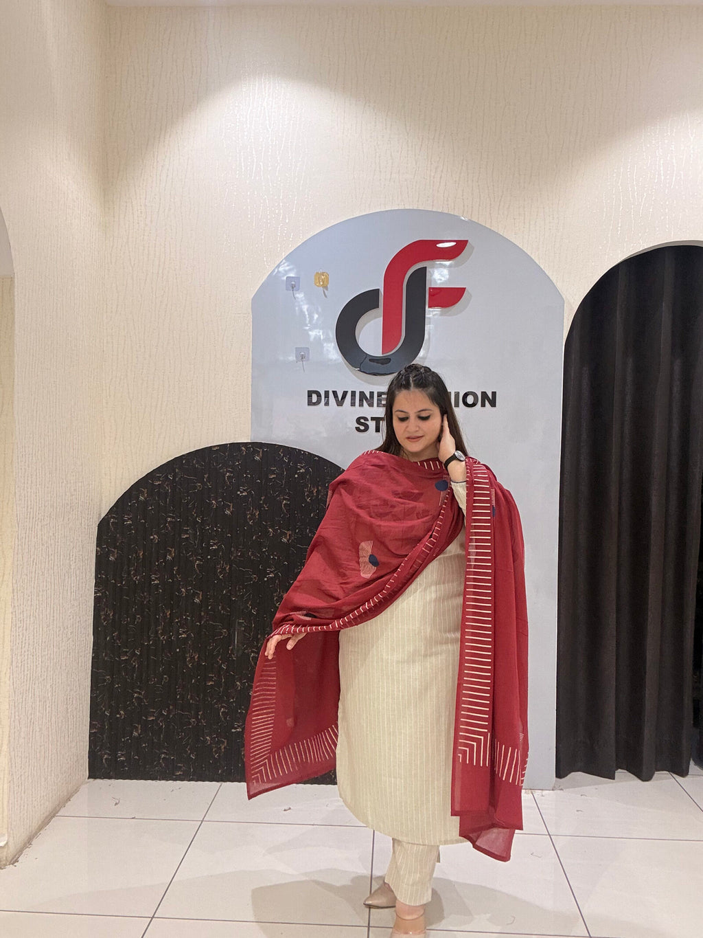 Elegant cream cotton suit featuring floral embroidery in red and blue tones, paired with a contrasting red dupatta.