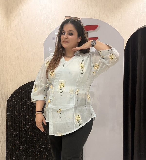 Stylish cotton tops featuring delicate yellow floral embroidery and sheer sleeves.