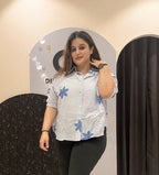 Trendy light blue cotton top featuring bold blue floral embroidery