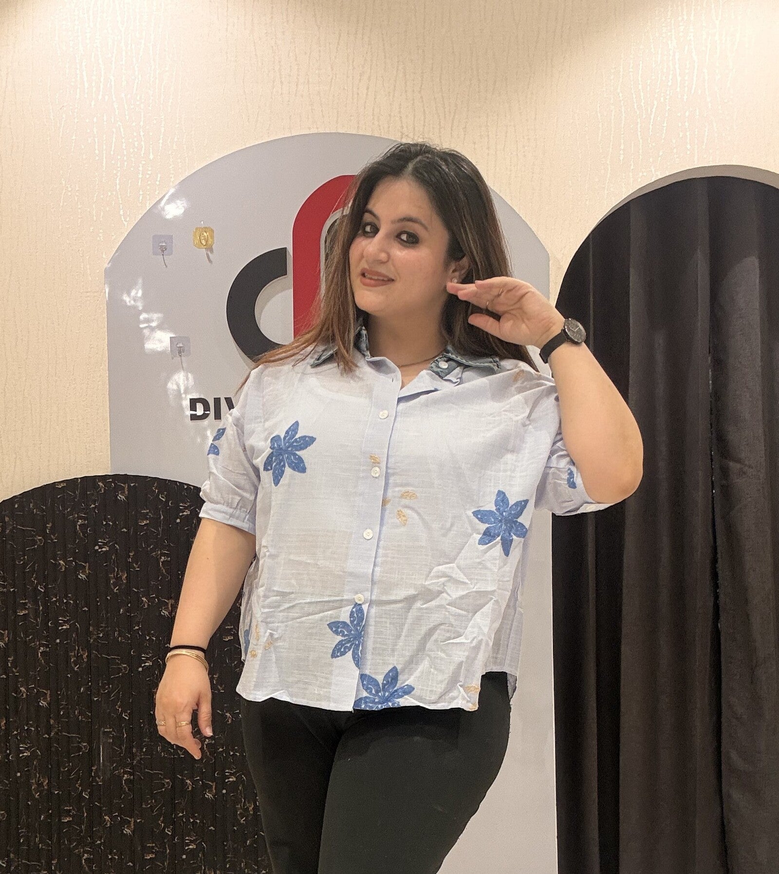 Trendy light blue cotton top featuring bold blue floral embroidery
