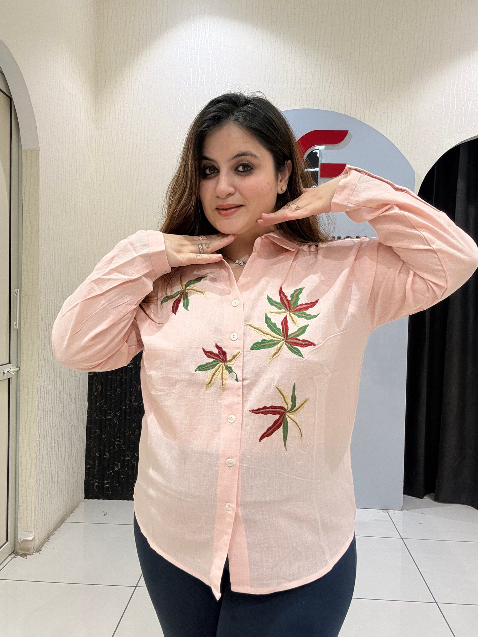 Chic pink linen cotton top featuring delicate leaf embroidery and a button-down design