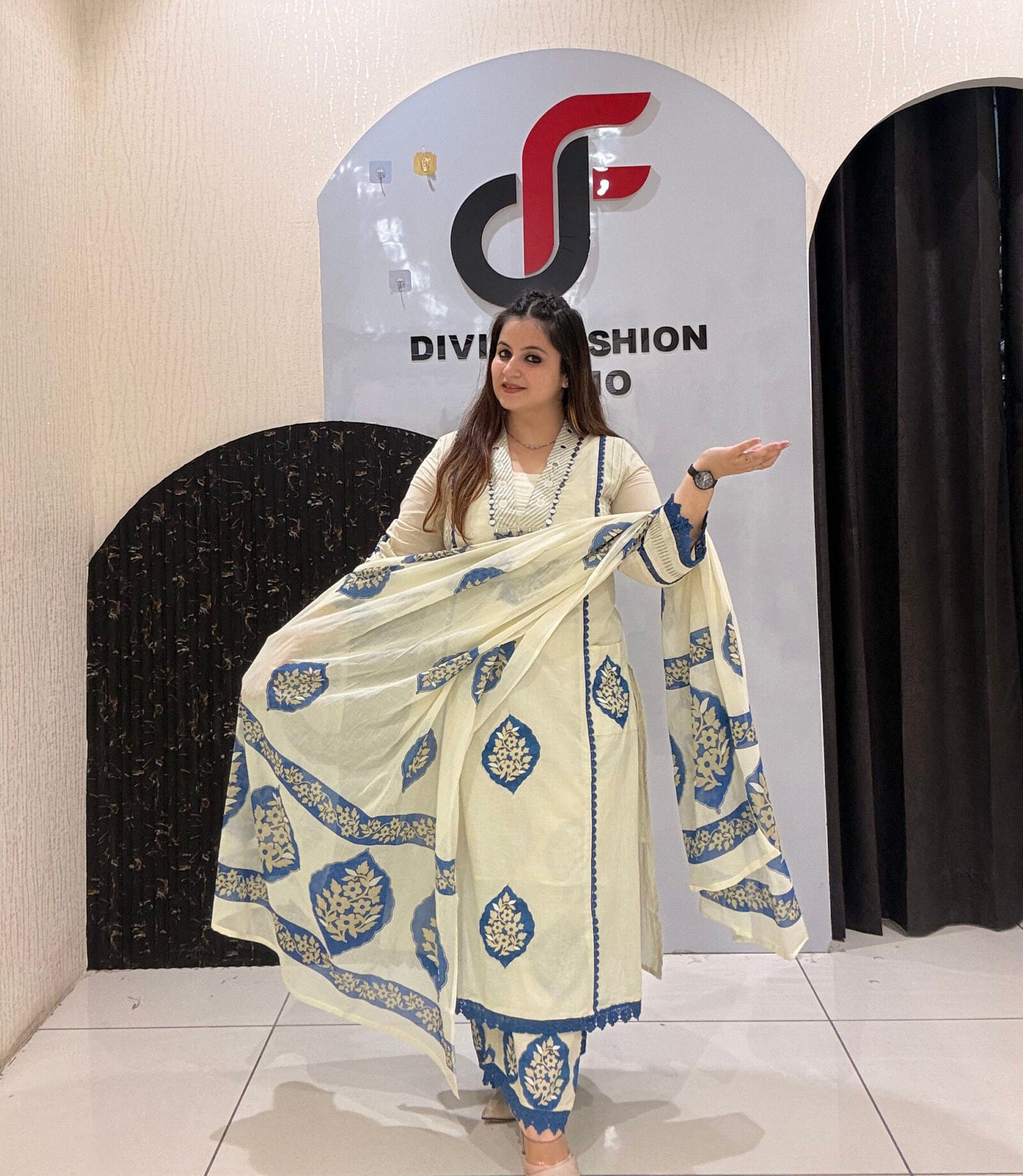 Graceful cream pure mul cotton suit featuring blue block-style prints and a matching dupatta.