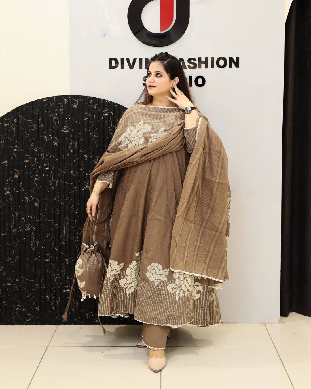 Elegant brown cotton suit set featuring beautiful floral prints, comfortable fabric, matching dupatta, and stylish ethnic appeal perfect for festive and casual wear.