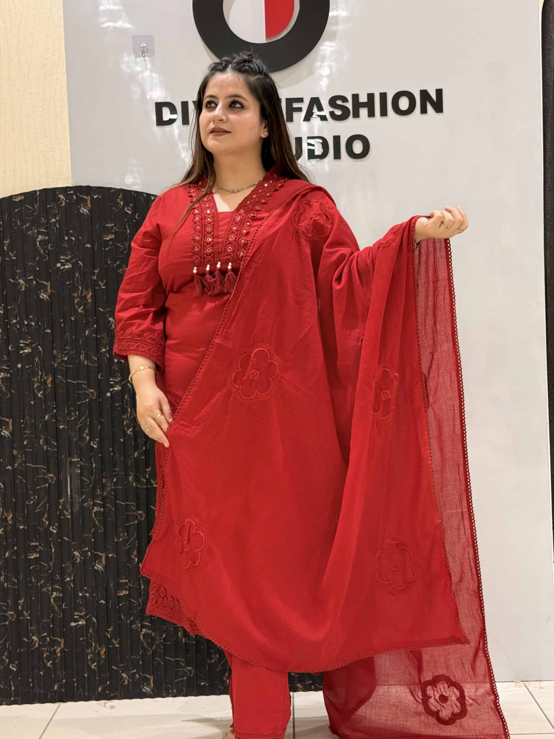 Woman in red floral embroidered co-ord set with tassel details