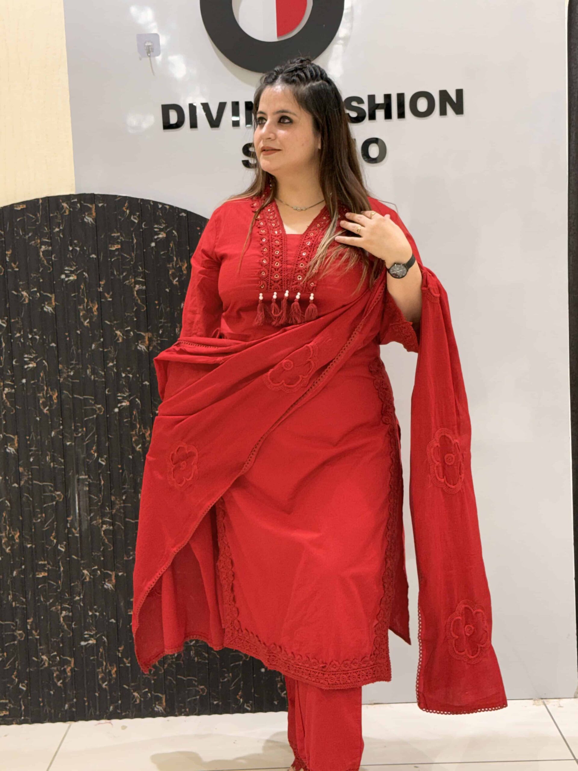 Elegant red cotton kurta set featuring intricate lace detailing and floral embroidery.