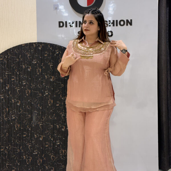 Woman in peach floral embroidered button-down co-ord set with wide-leg pants.
