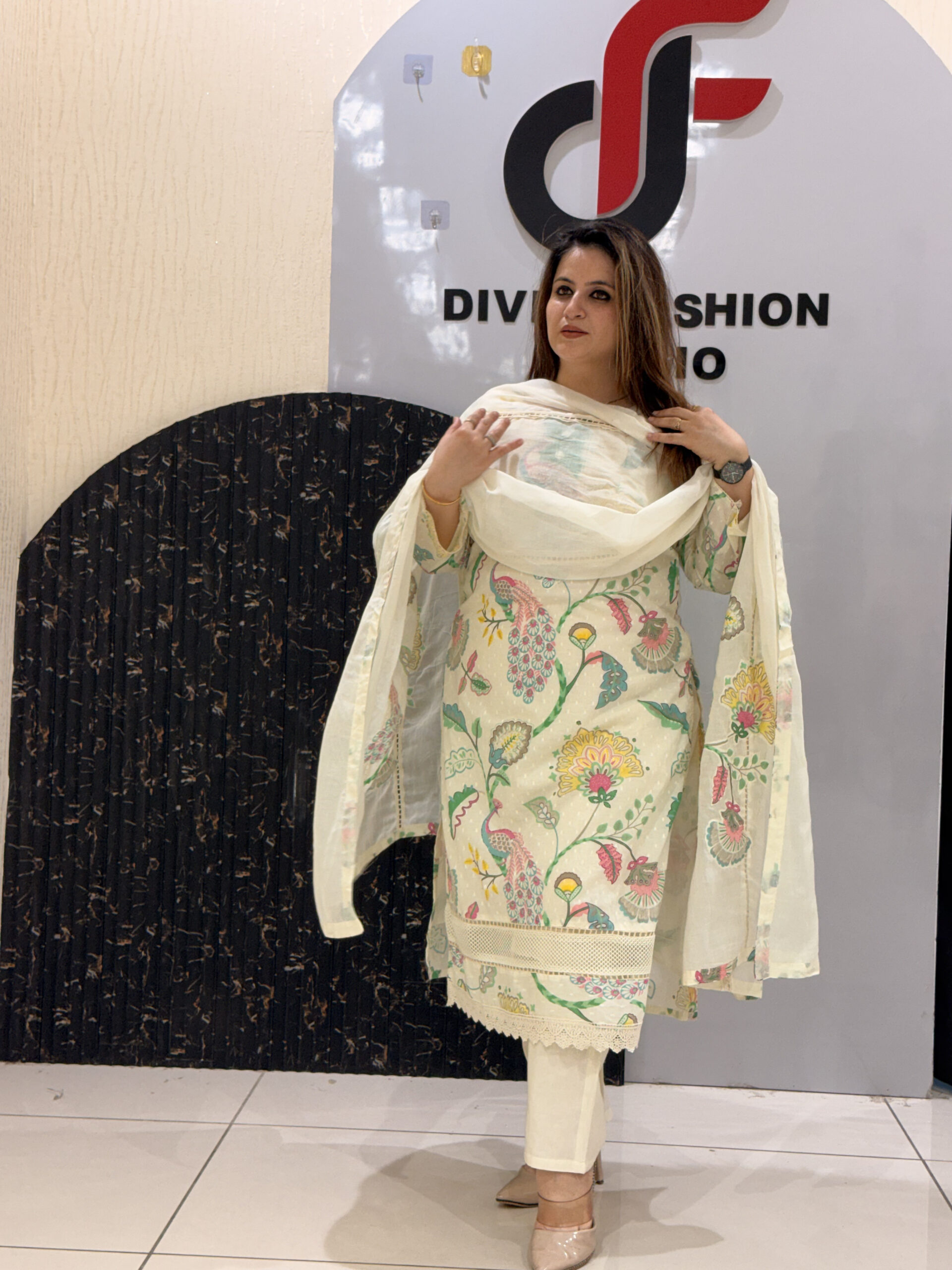 Woman in a cream floral embroidered button-down co-ord set with a matching dupatta.