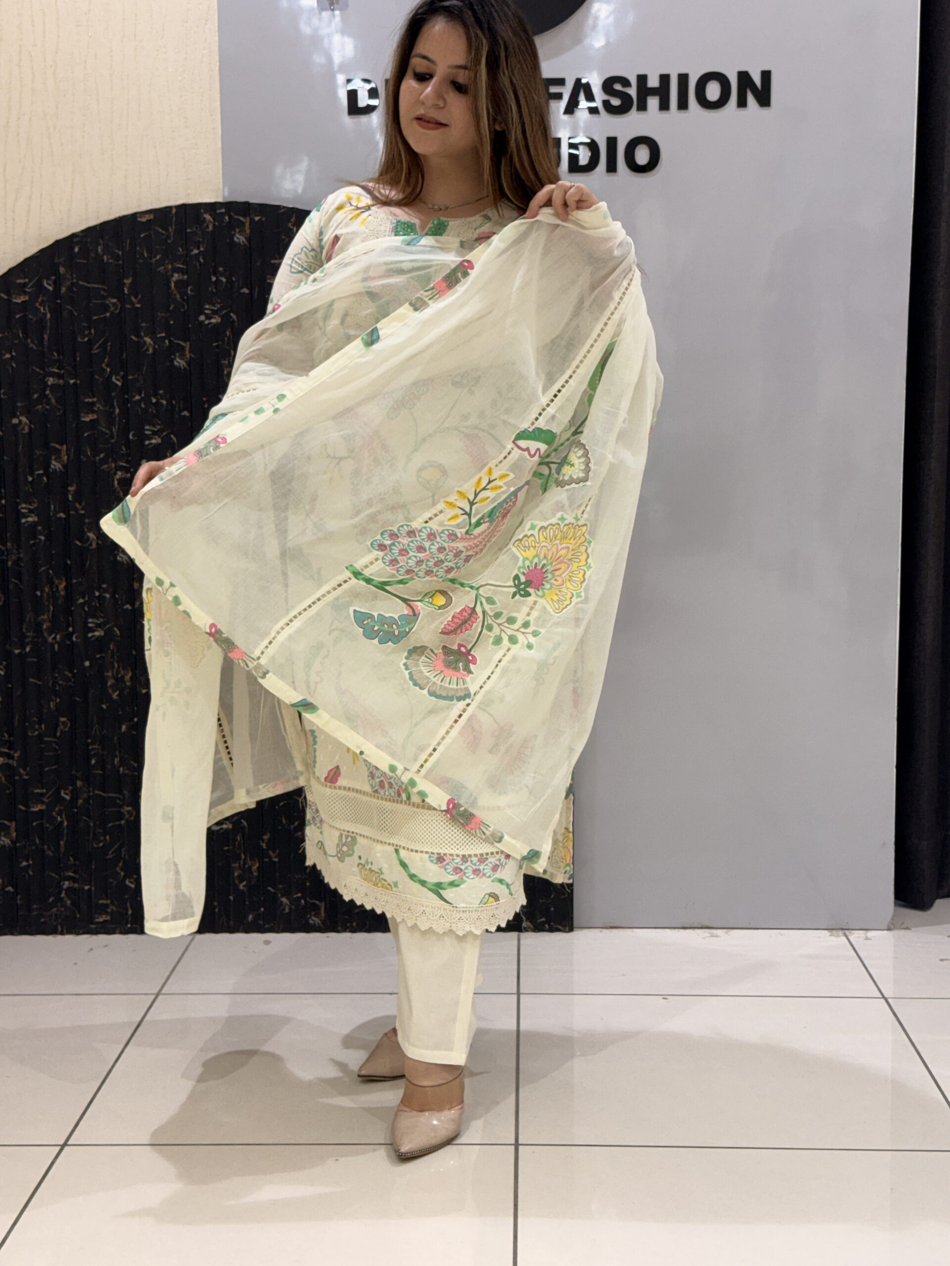 Woman in a cream floral embroidered button-down co-ord set with matching pants and dupatta.