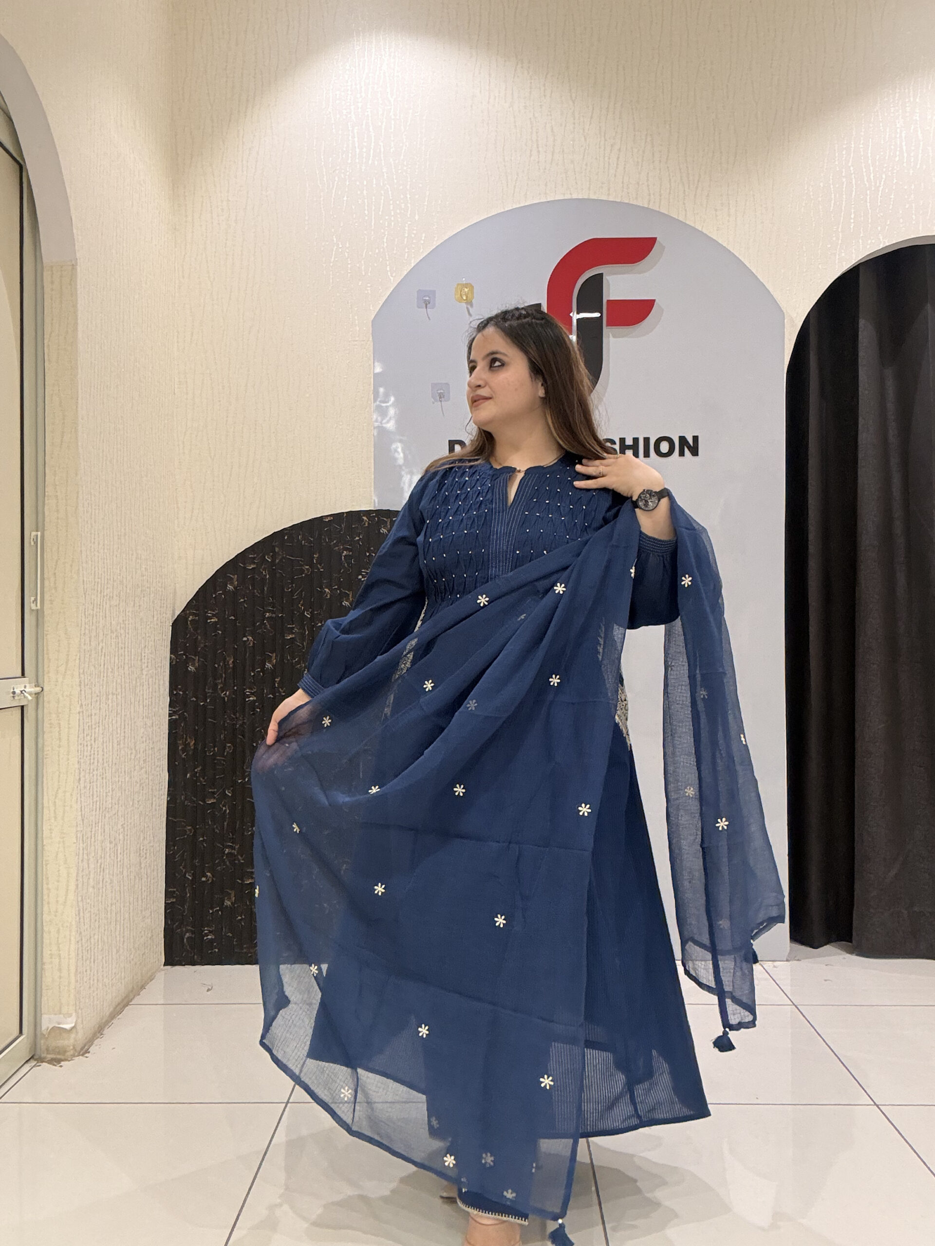 Graceful navy blue pure cotton suit featuring delicate pocket embroidery and a lightweight Kota Doria dupatta.