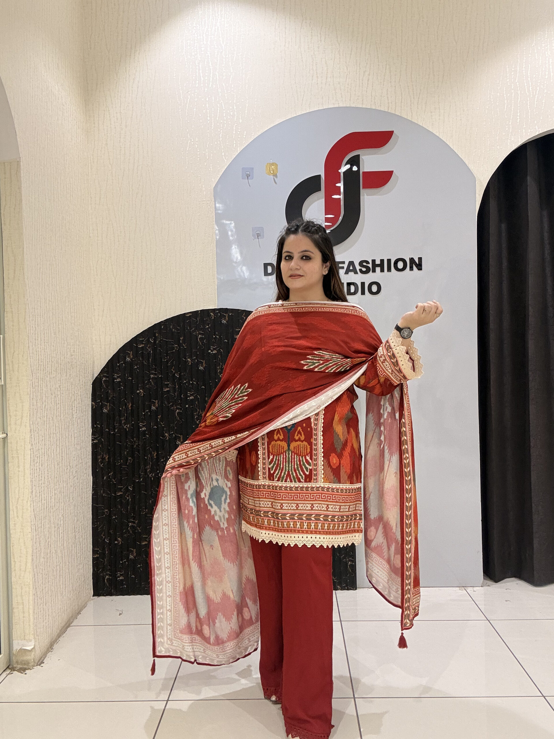 Elegant red cotton suit set featuring intricate multicolor embroidery and a matching printed dupatta.