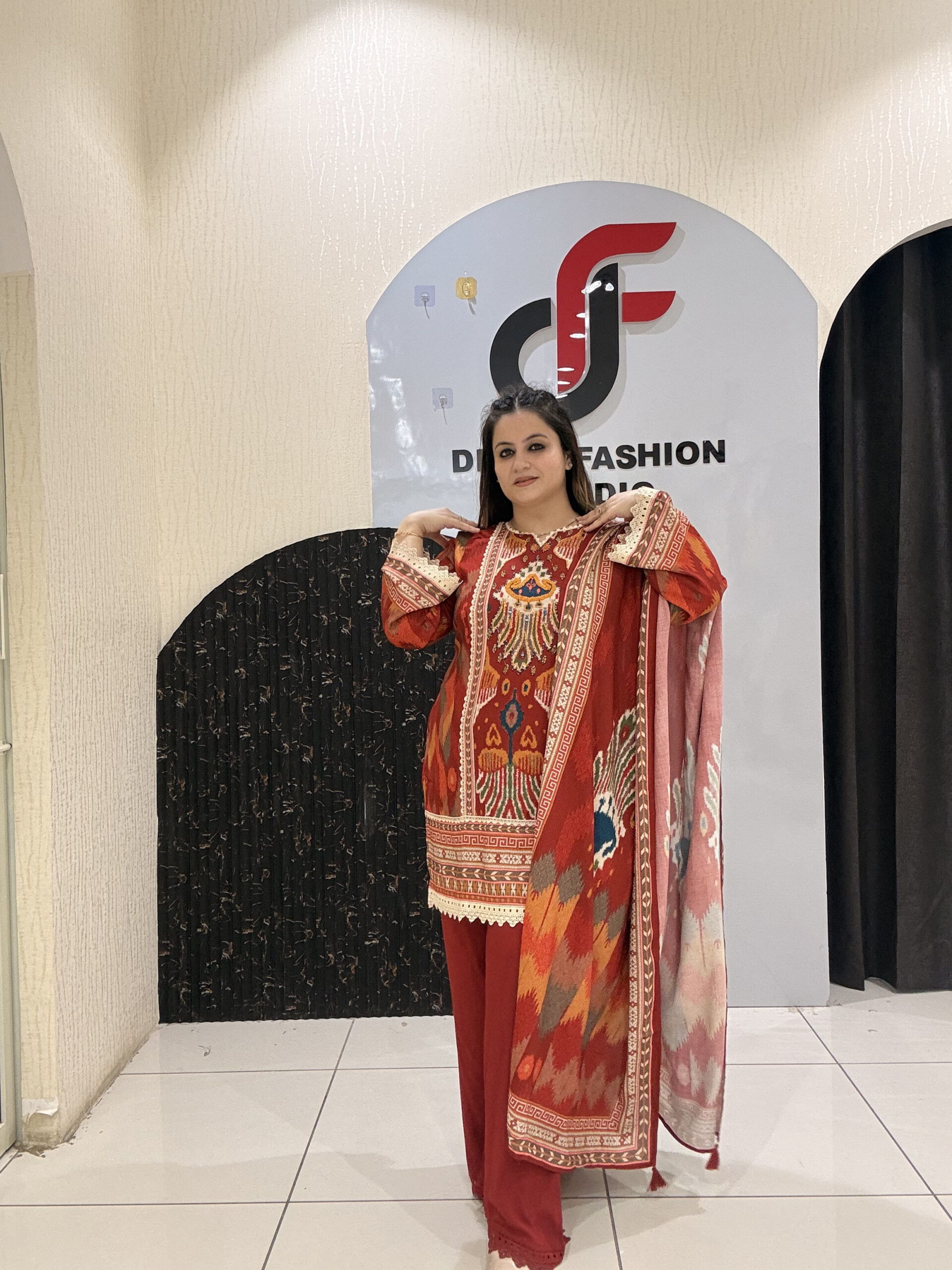 Elegant red cotton suit set featuring intricate multicolor embroidery and a matching printed dupatta.