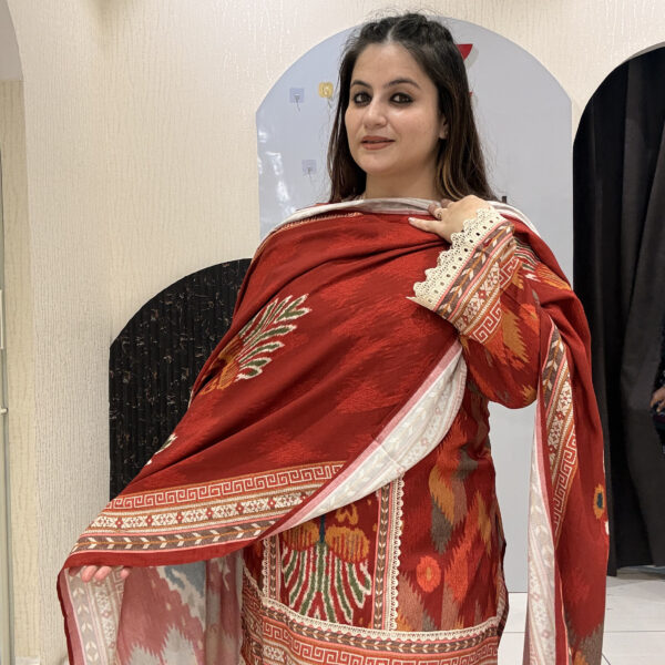 Elegant red cotton suit set featuring intricate multicolor embroidery and a matching printed dupatta.
