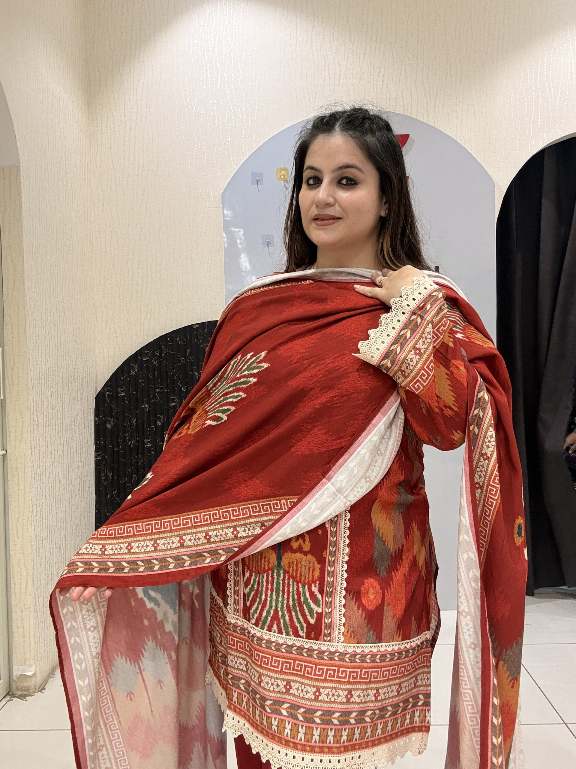 Elegant red cotton suit set featuring intricate multicolor embroidery and a matching printed dupatta.