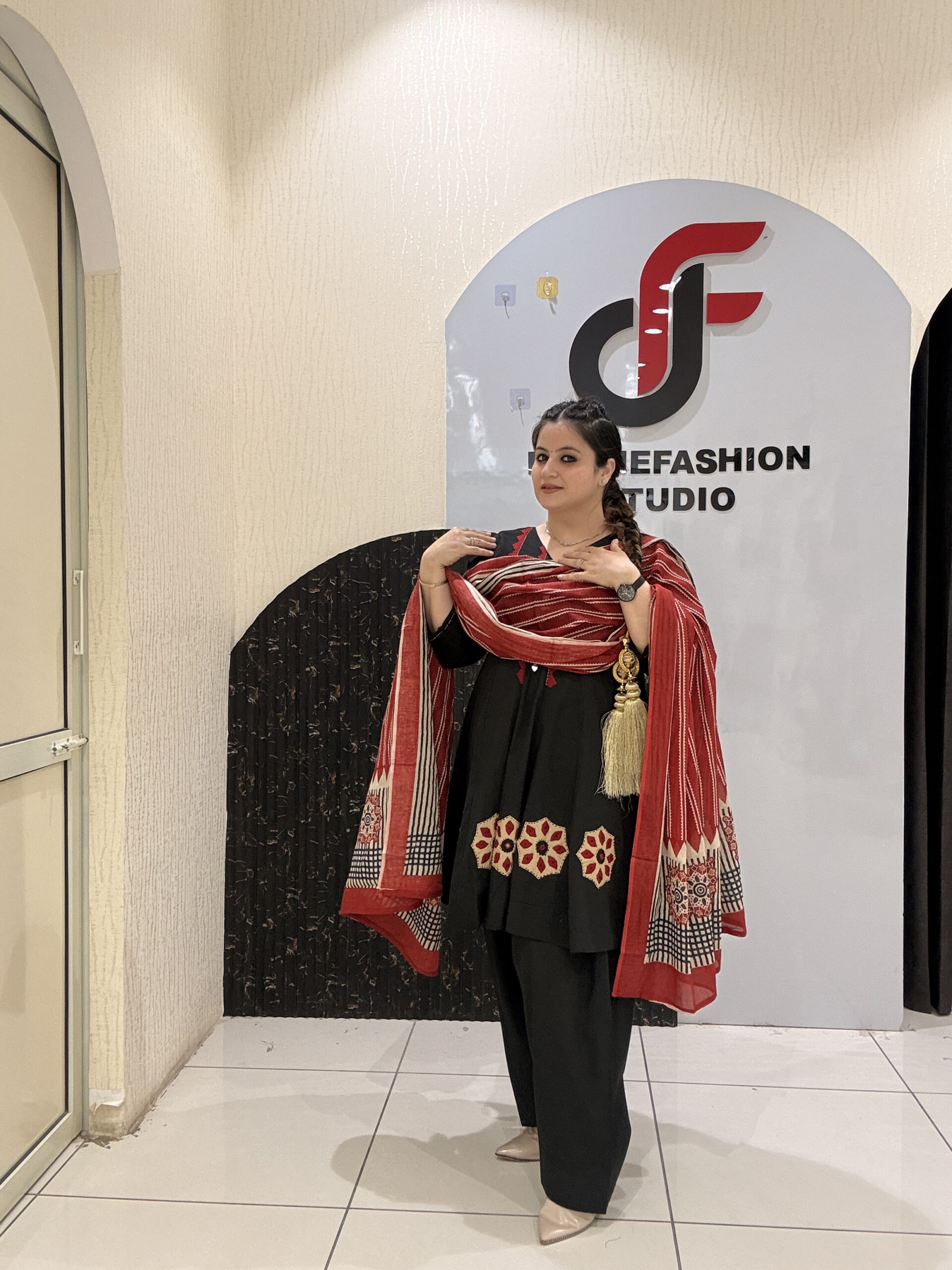 Elegant black pure cotton suit set featuring red and beige embroidery with a matching printed dupatta