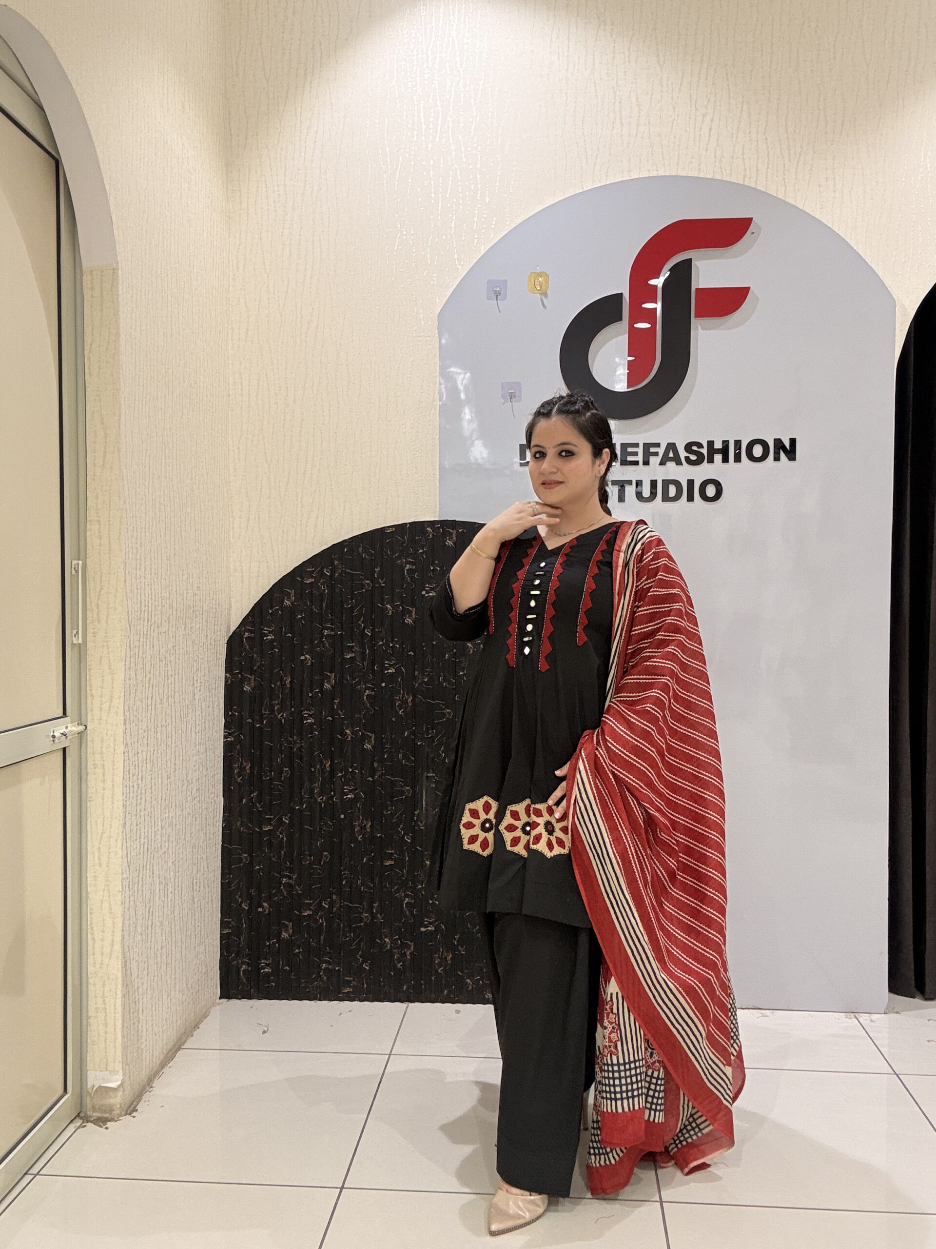Elegant black pure cotton suit set featuring red and beige embroidery with a matching printed dupatta