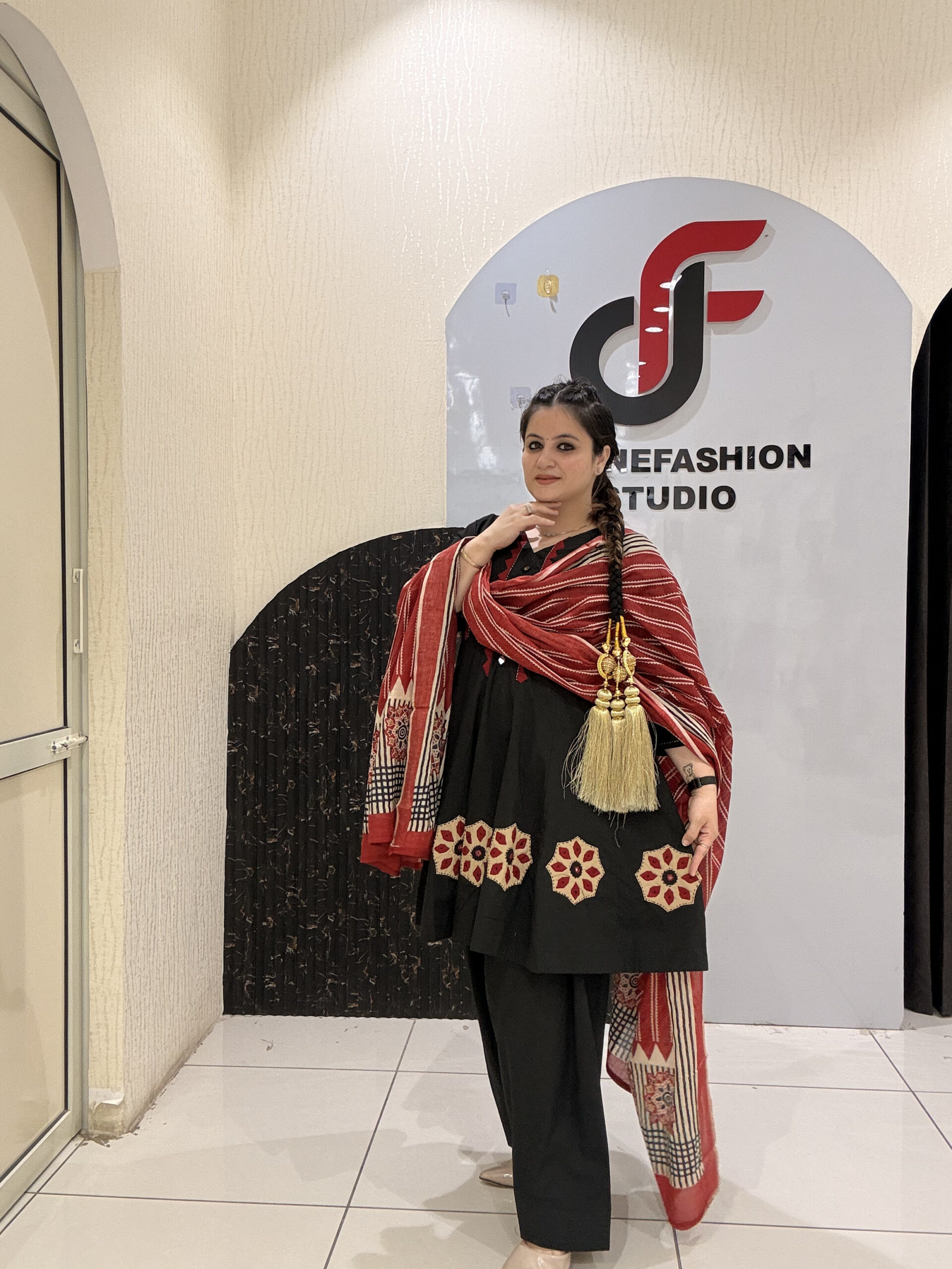 Elegant black pure cotton suit set featuring red and beige embroidery with a matching printed dupatta