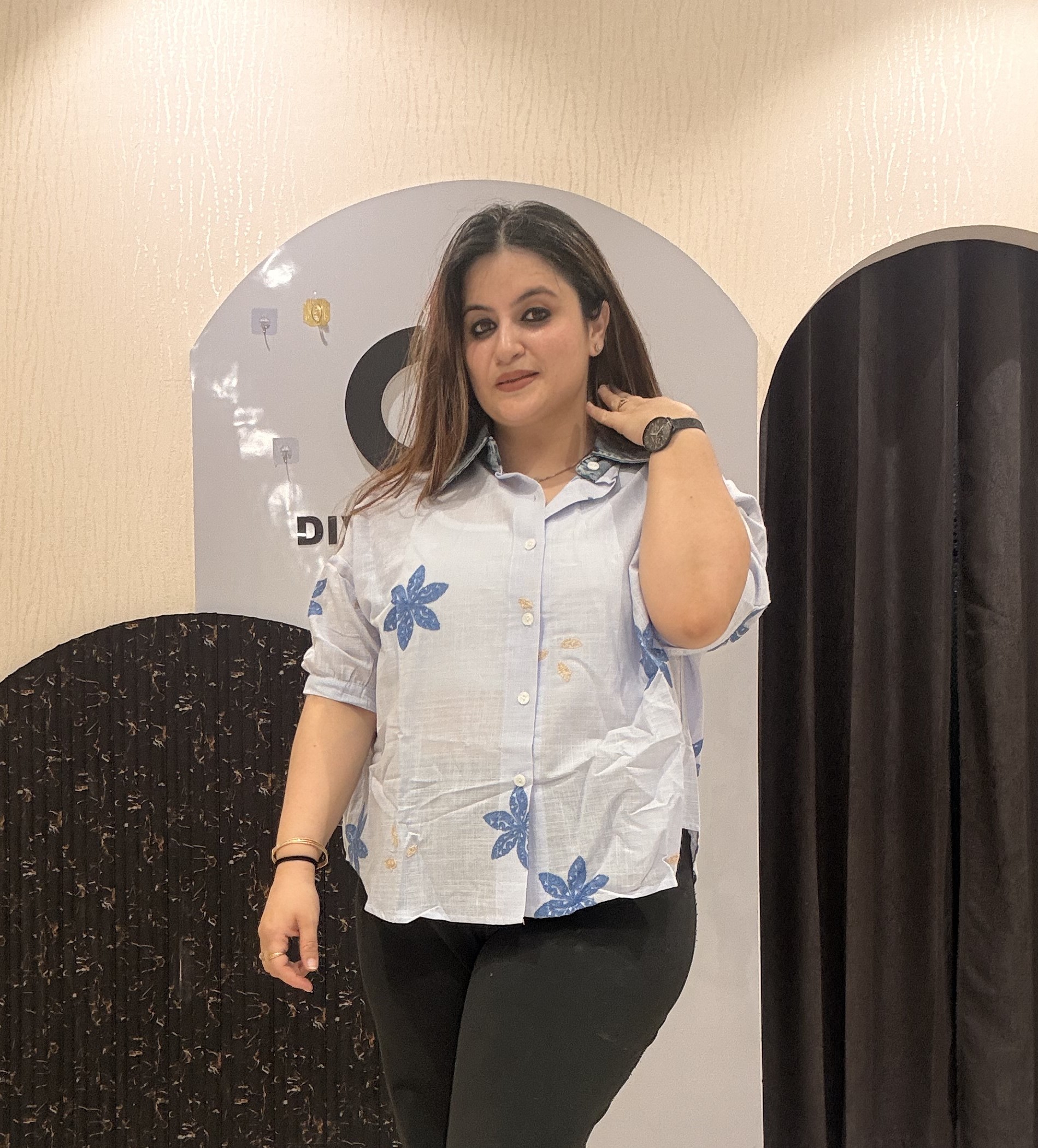 Trendy light blue cotton top featuring bold blue floral embroidery