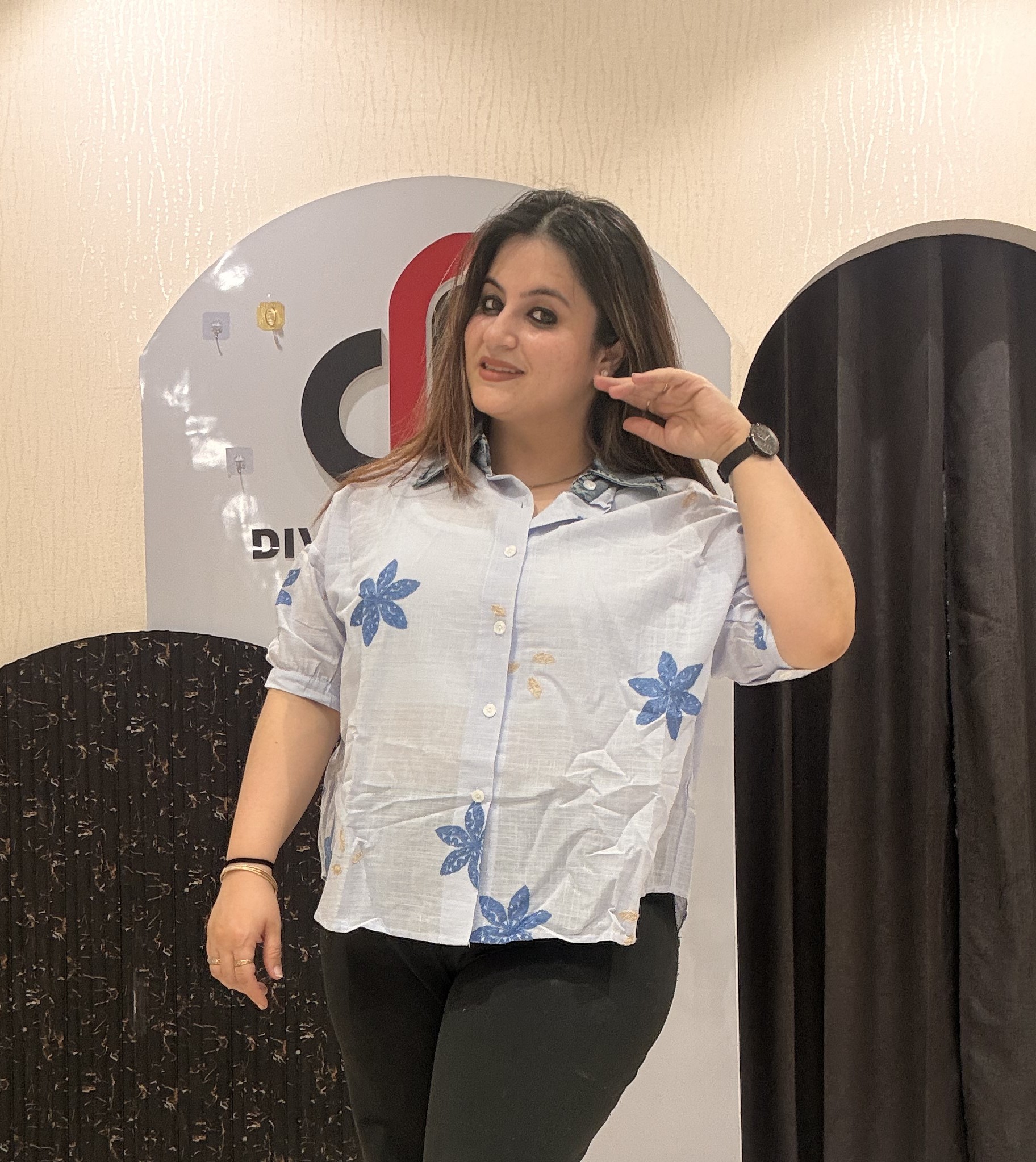 Trendy light blue cotton top featuring bold blue floral embroidery