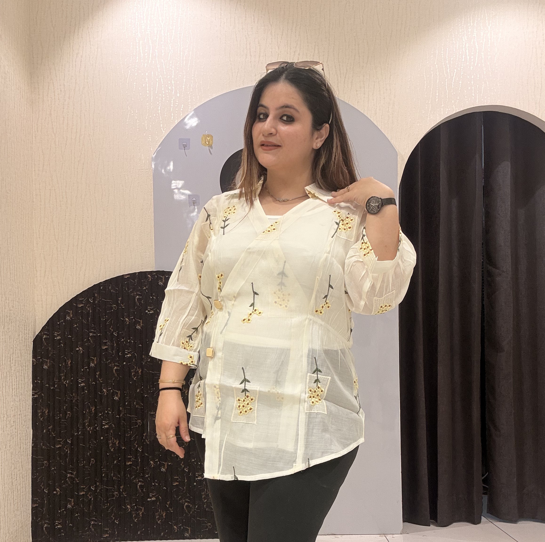 Stylish cotton tops featuring delicate yellow floral embroidery and sheer sleeves.