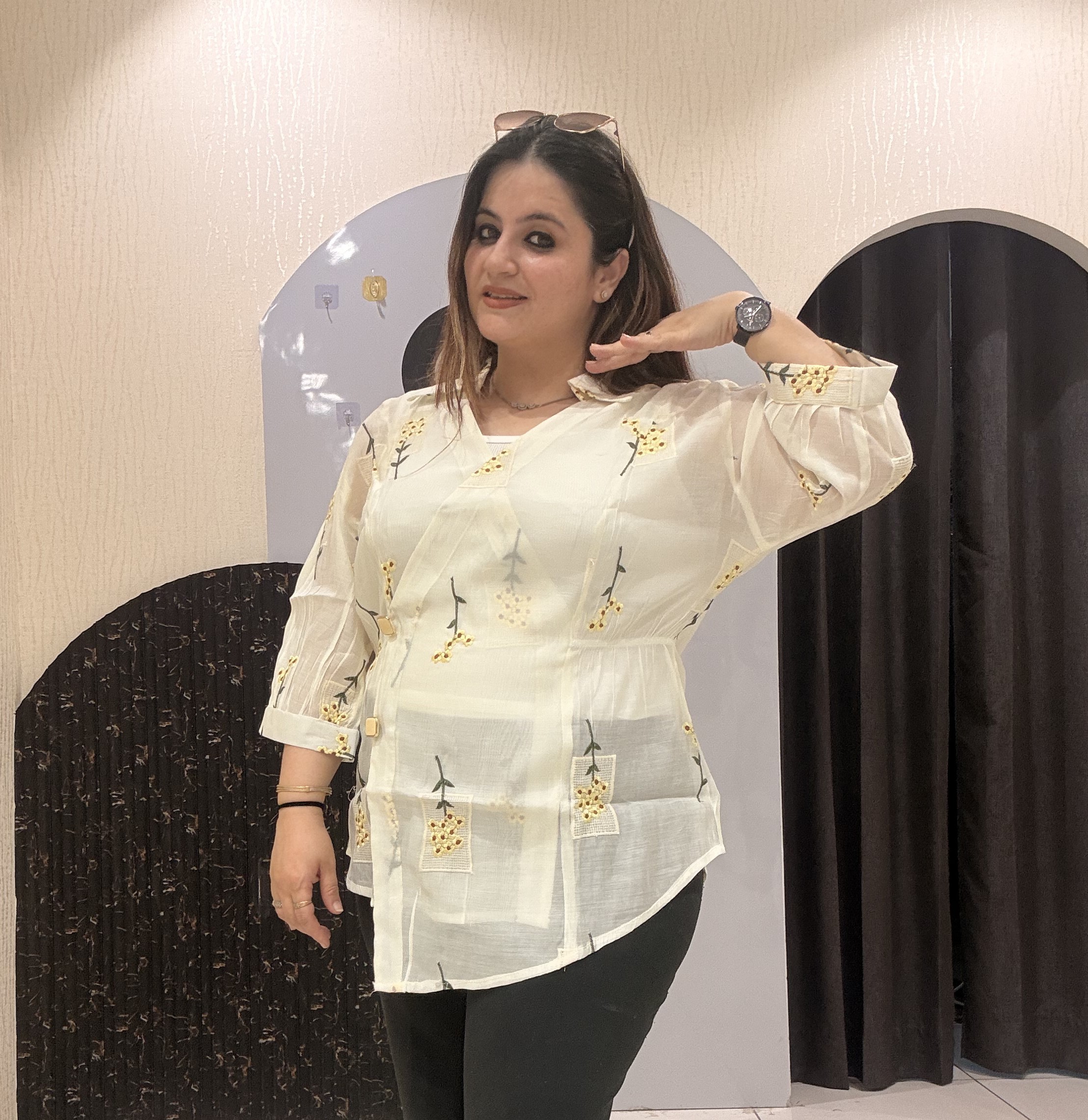 Stylish cotton tops featuring delicate yellow floral embroidery and sheer sleeves.