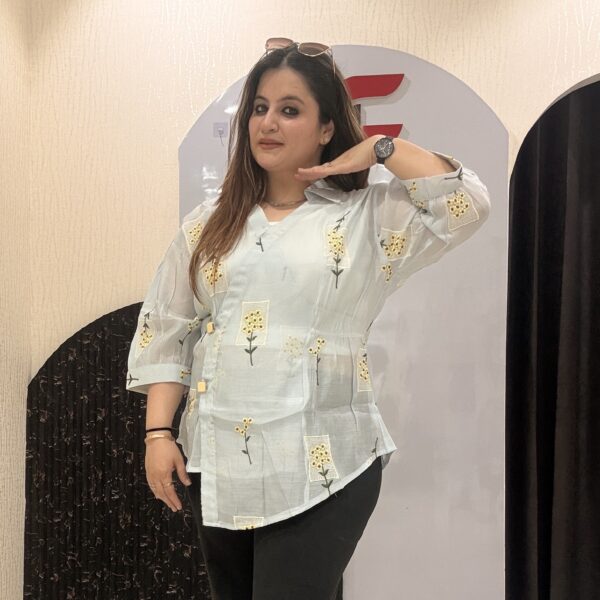 Stylish cotton tops featuring delicate yellow floral embroidery and sheer sleeves.