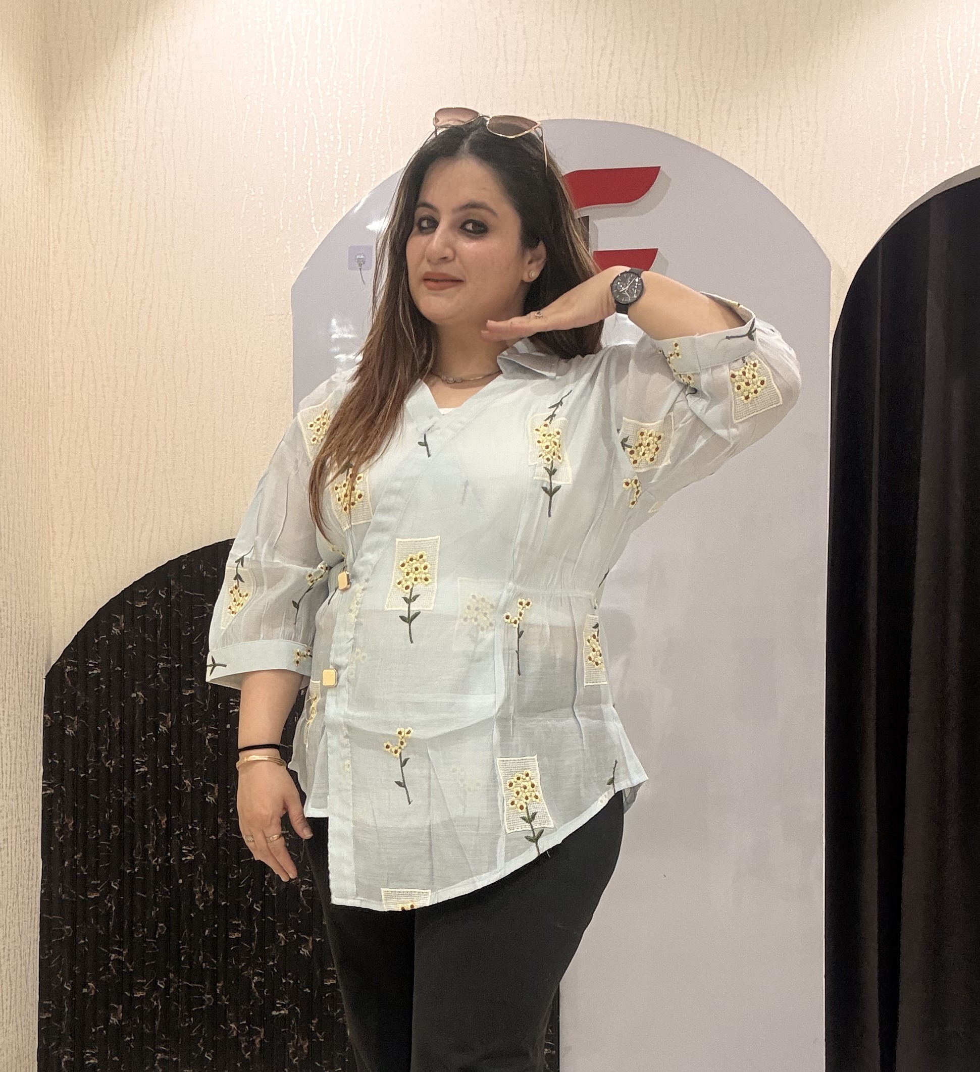 Stylish cotton tops featuring delicate yellow floral embroidery and sheer sleeves.