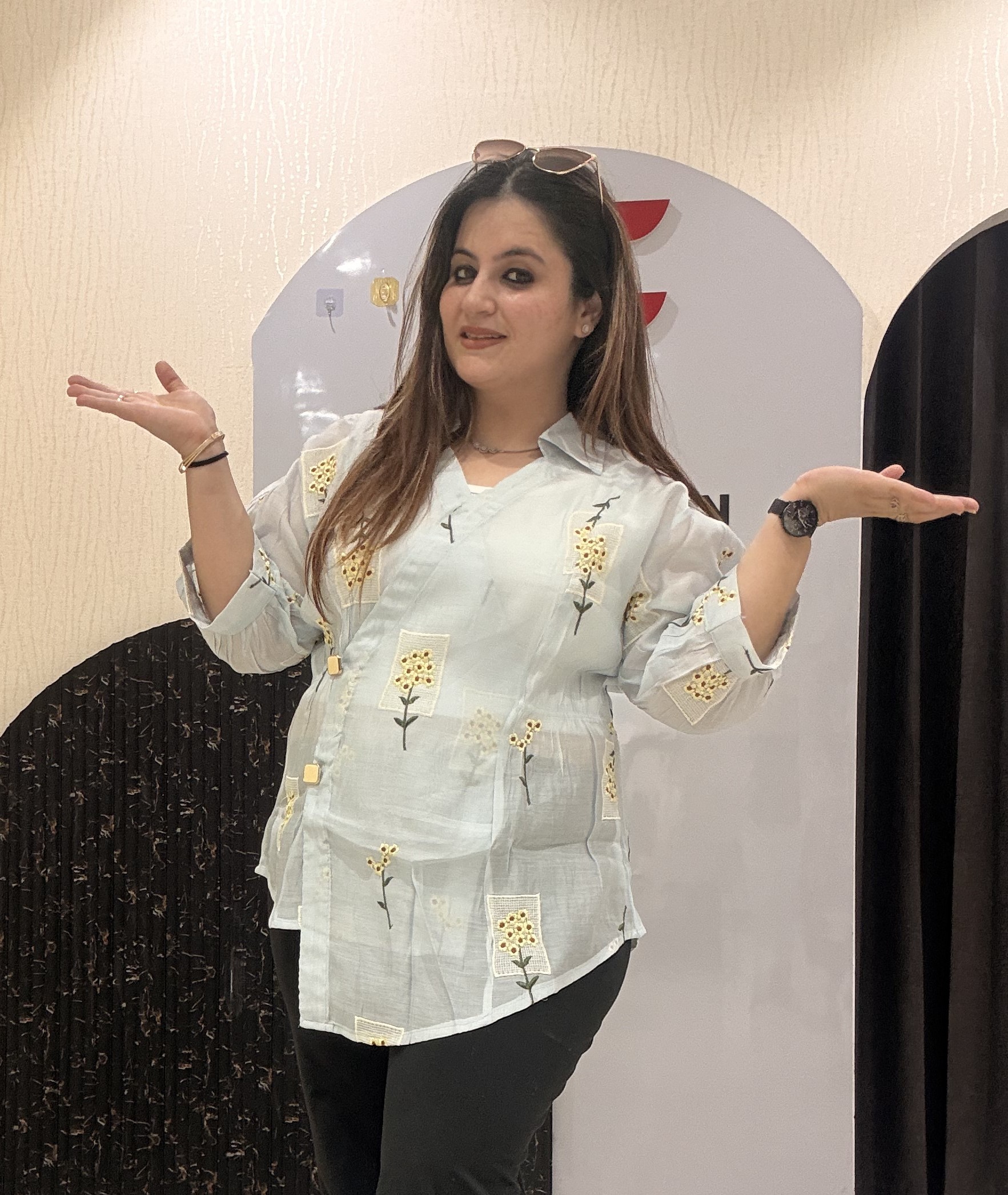 Stylish cotton tops featuring delicate yellow floral embroidery and sheer sleeves.