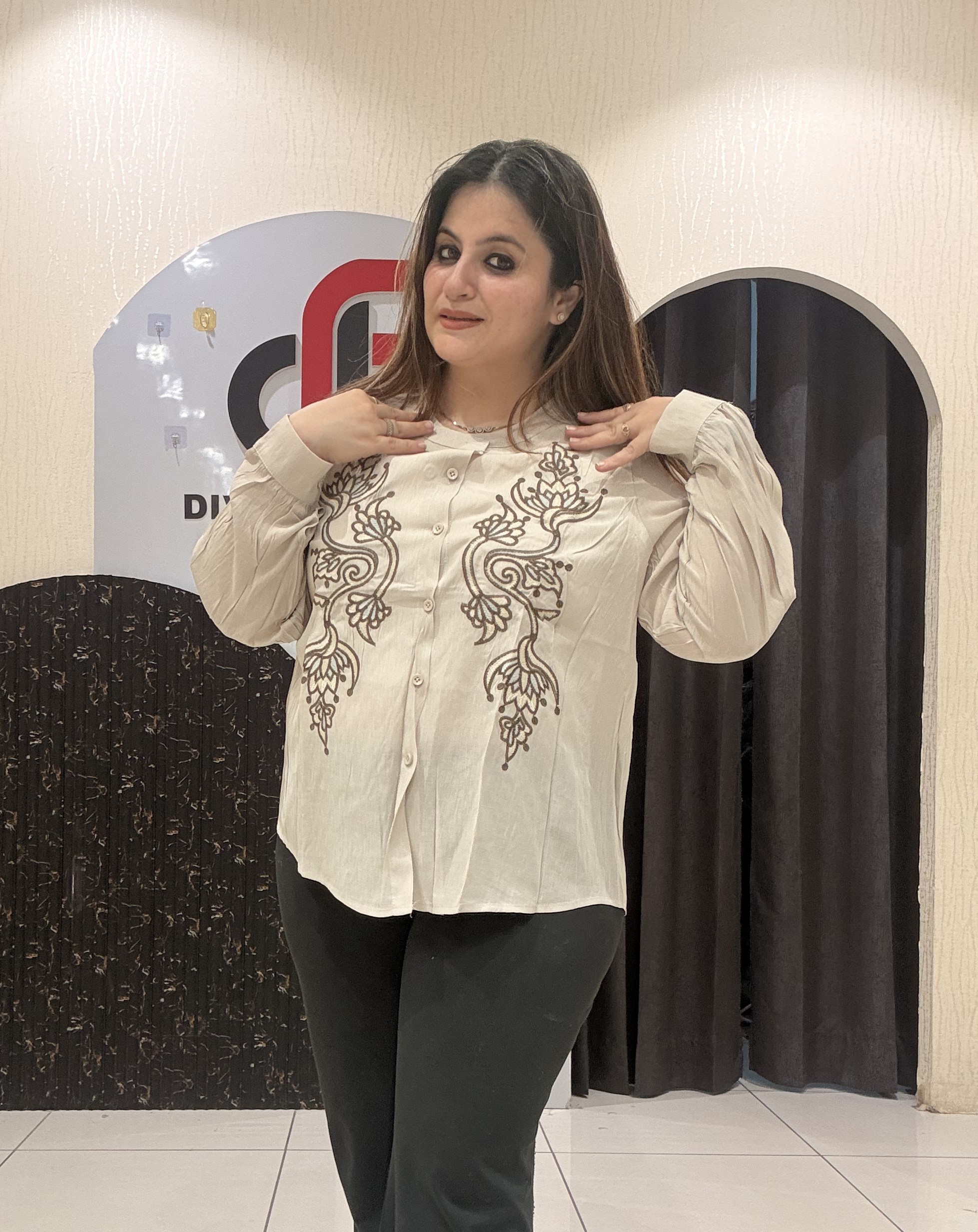 Stylish tops featuring intricate front embroidery and a classic button-up design