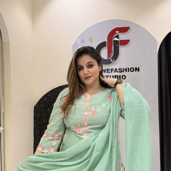 Graceful mint green cotton suit featuring intricate floral embroidery and tassel detailing.