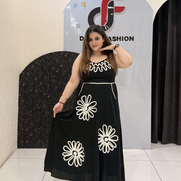 Stylish cotton middi dress featuring bold floral embroidery and a wavy neckline design.