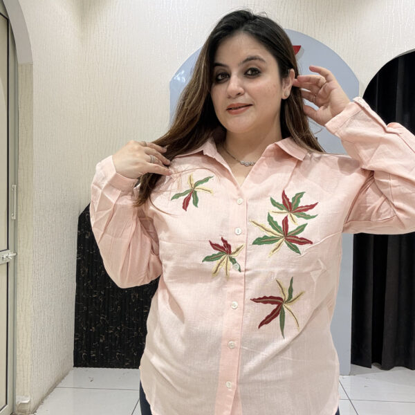 Chic pink linen cotton top featuring delicate leaf embroidery and a button-down design